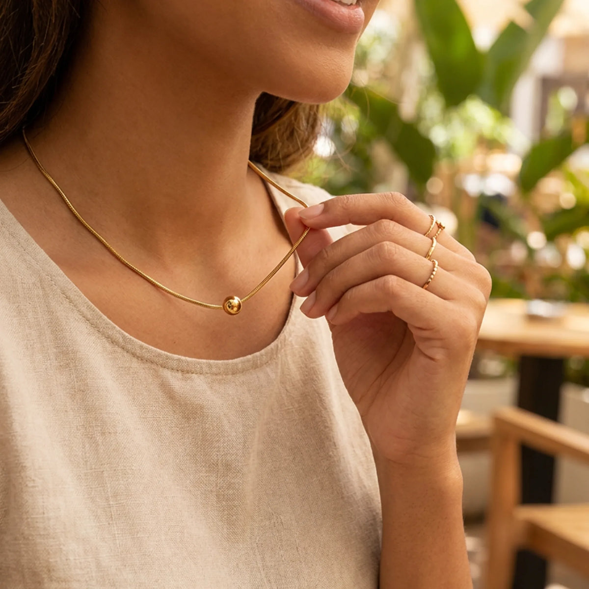 Customized Necklace by Urban Heaven in White / Gold color, shown in a lifestyle setting