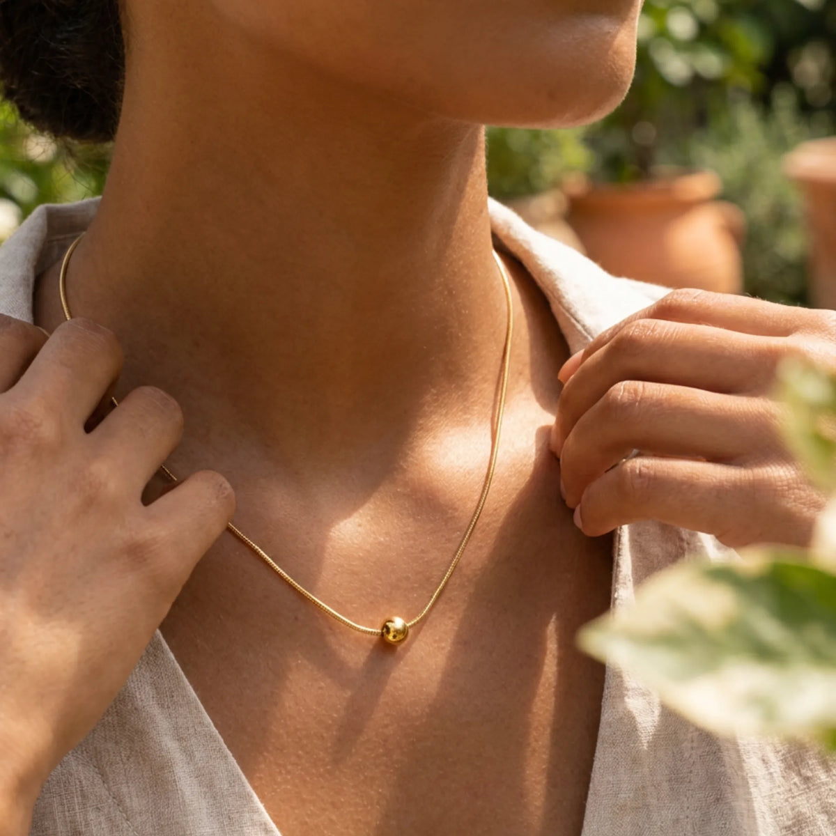 customized necklace in Gold / Gold color, shown in a lifestyle setting