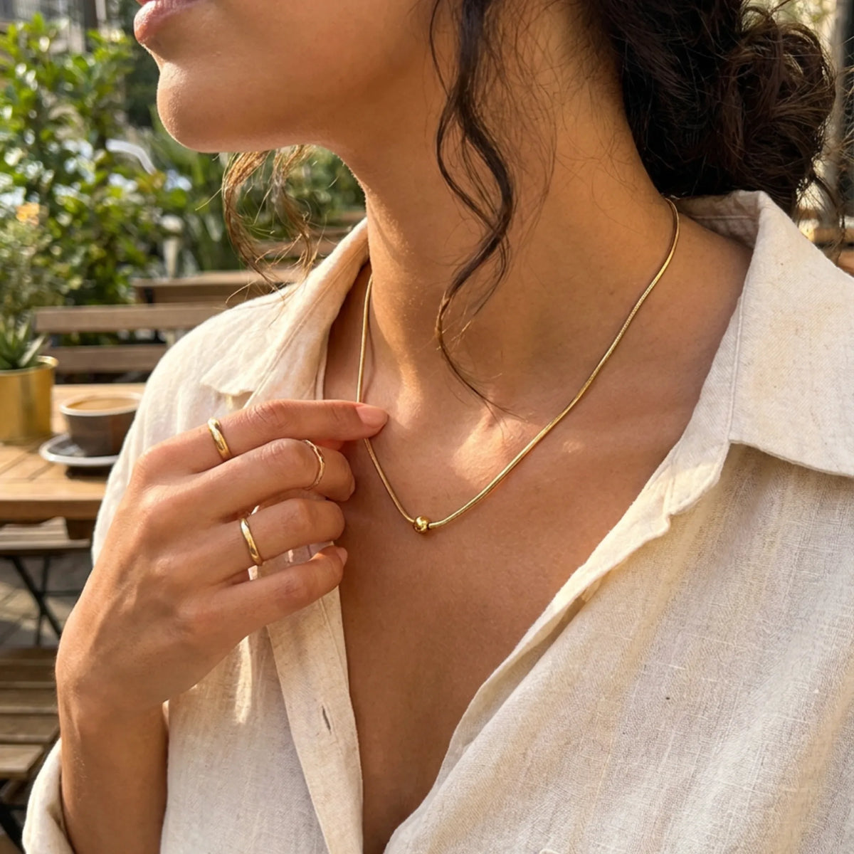 customized necklace in Gold / Gold color, shown in a lifestyle setting